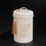 Tin Box Round tinplate can with vertical ribbed finish, handle, and tassel.
